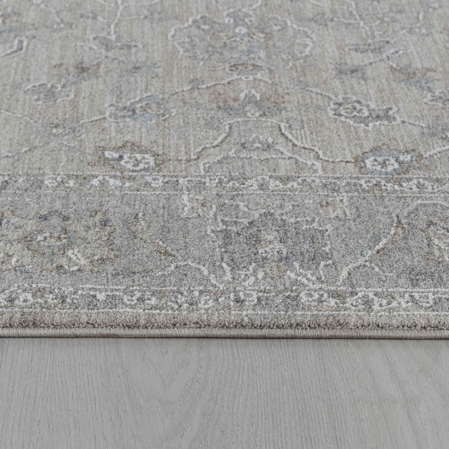 Gray patterned rug on wooden floor