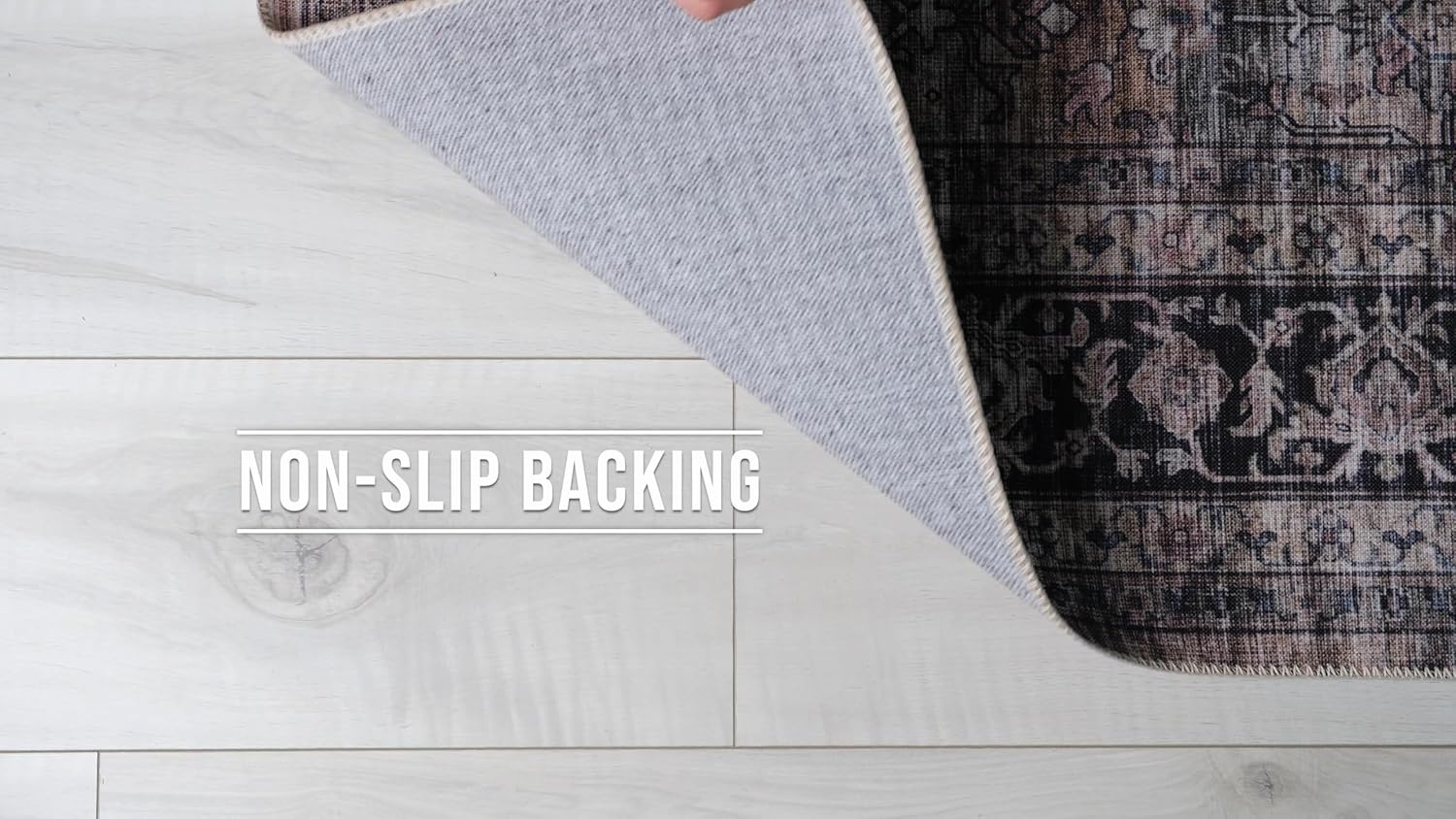 Area rug with non-slip backing on wood floor.