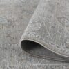 Gray woven carpet with intricate patterns displayed.