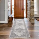 Elegant entryway with patterned hallway runner rug.