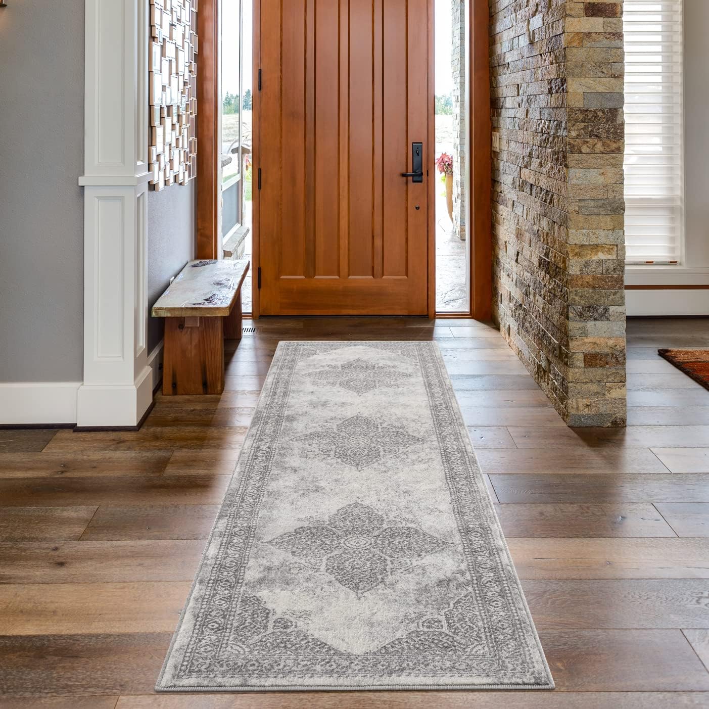 Elegant entryway with patterned hallway runner rug.