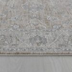 Gray patterned rug on wooden floor