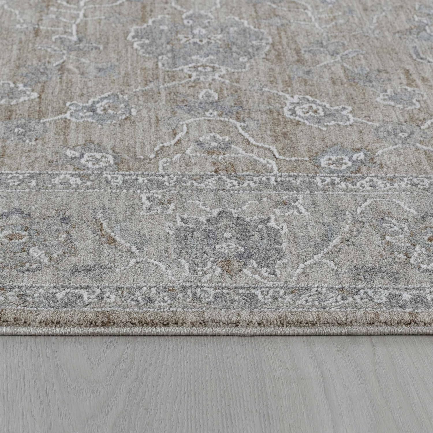 Gray patterned rug on wooden floor