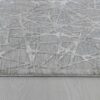 Modern rug with abstract gray pattern design.