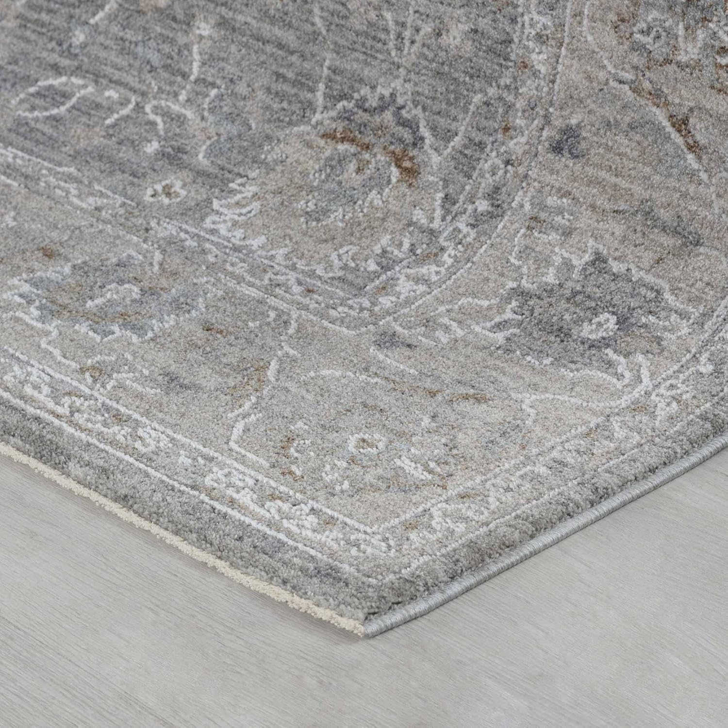 Gray patterned rug on wooden floor