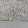 Textured beige rug on light wood floor.