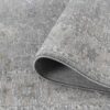 Gray patterned rug with folded corner detail