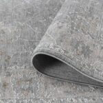 Gray patterned rug with folded corner detail