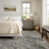 Cozy bedroom with beige bedding and large window