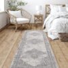 Cozy bedroom with patterned rug and wicker chair.