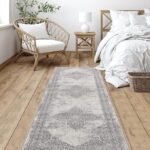 Cozy bedroom with patterned rug and wicker chair.