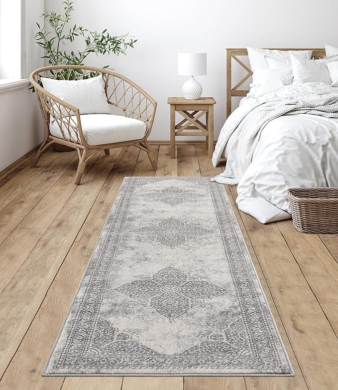 Cozy bedroom with patterned rug and wicker chair.