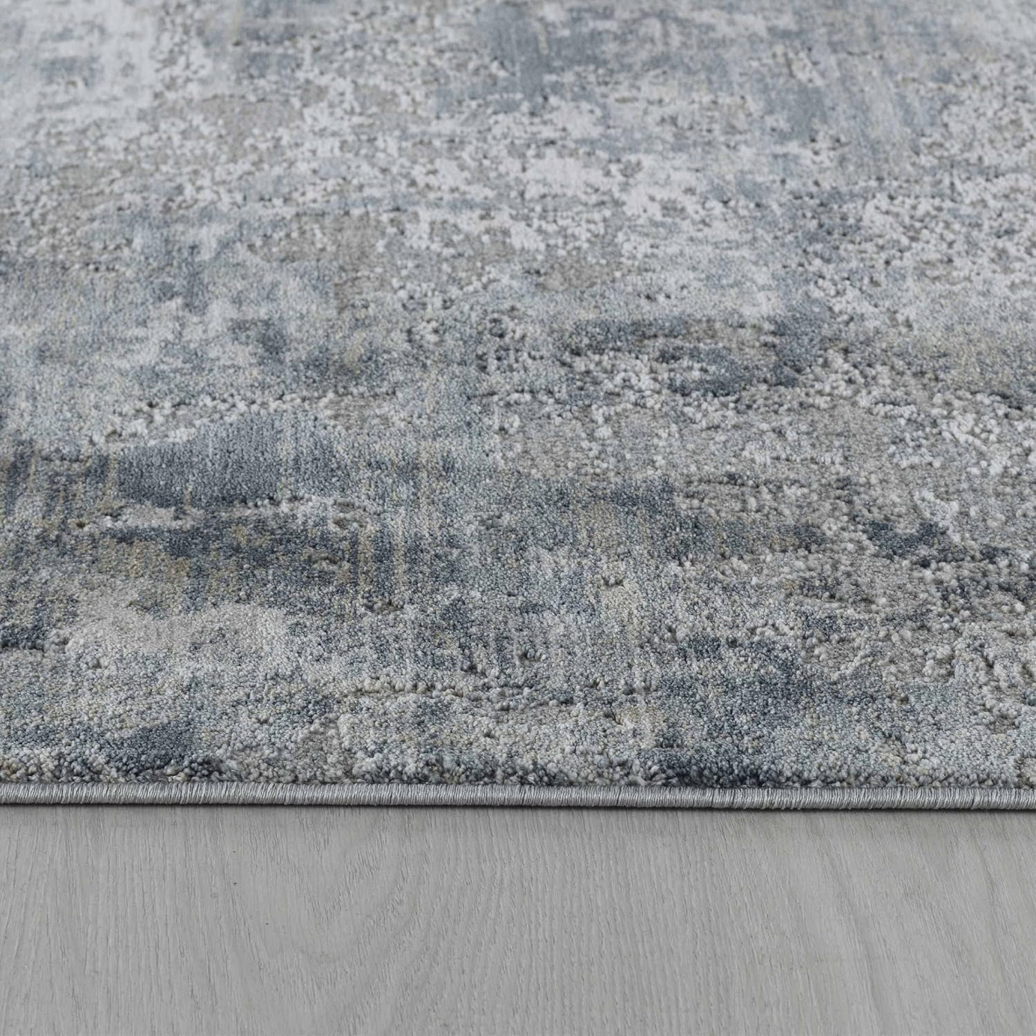 Abstract gray and blue textured area rug.