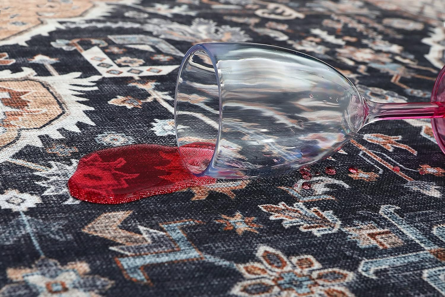 Red wine spilled from glass on carpet