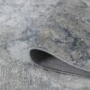 Close-up of textured gray rug corner.