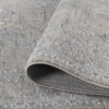 Beige patterned area rug rolled corner