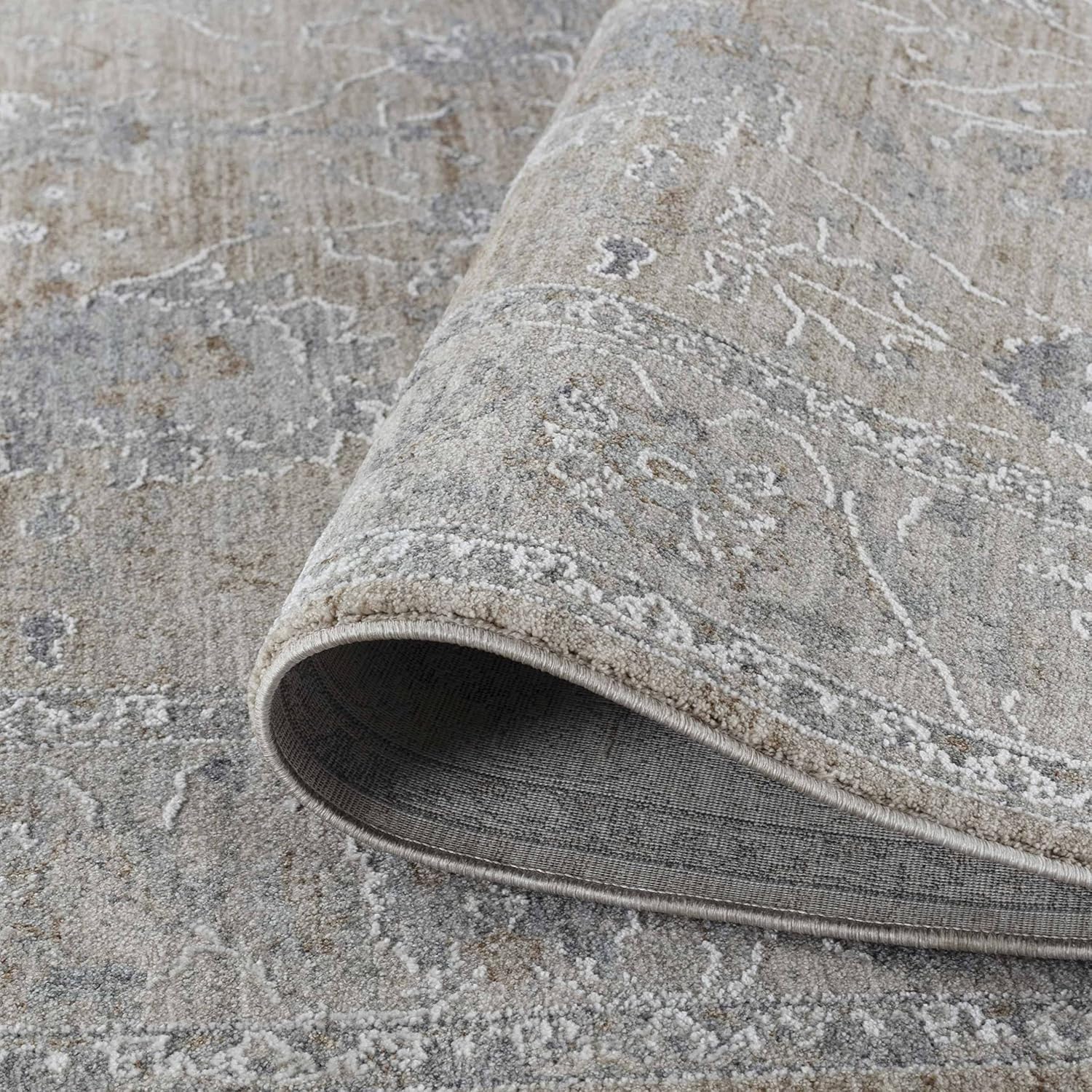 Beige patterned area rug rolled corner
