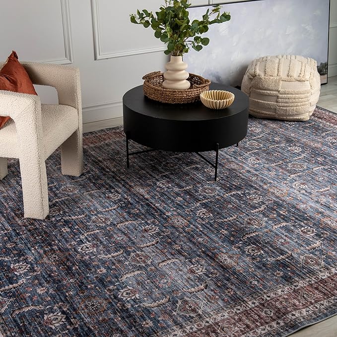 Stylish living room with patterned blue rug.