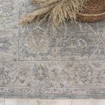 Gray decorative rug with woven basket and pampas grass.