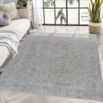 Living room with elegant patterned rug and modern decor.