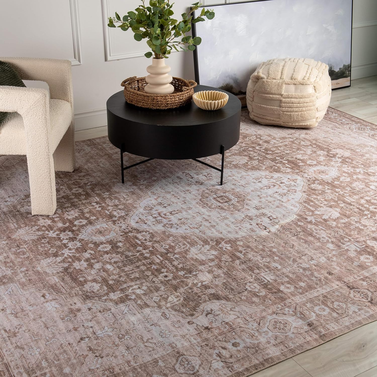 Cozy living room with patterned rug and round table.