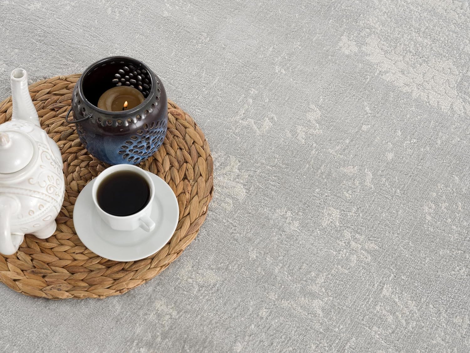 Tea set and candle on woven mat