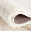Close-up of fluffy white carpet corner.
