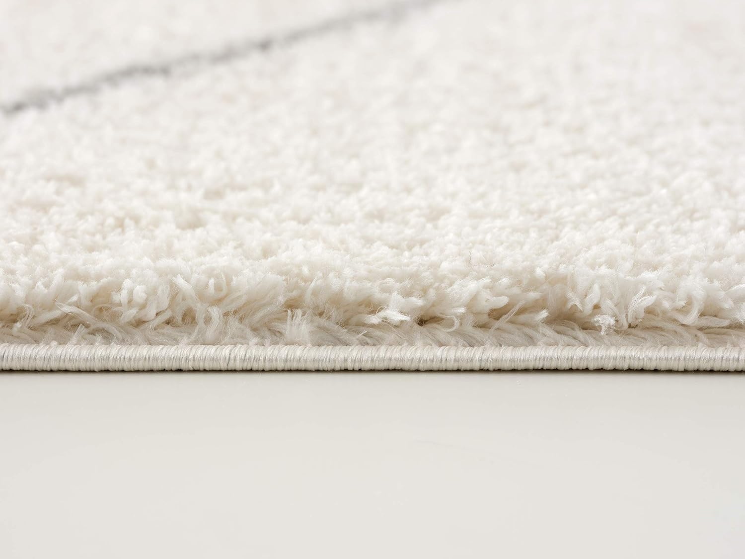 Close-up of a white shag rug texture.
