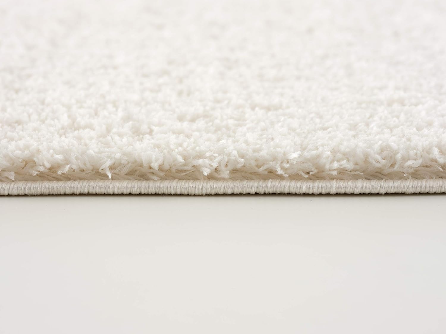 Close-up of fluffy white carpet edge