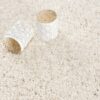 White candles on textured cream rug