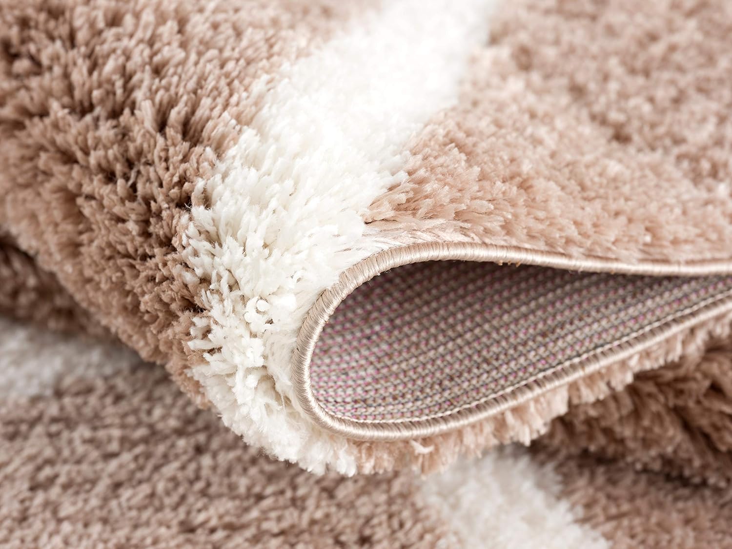 Close-up of fluffy beige and white carpet
