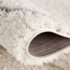 Close-up of fluffy, soft white carpet corner