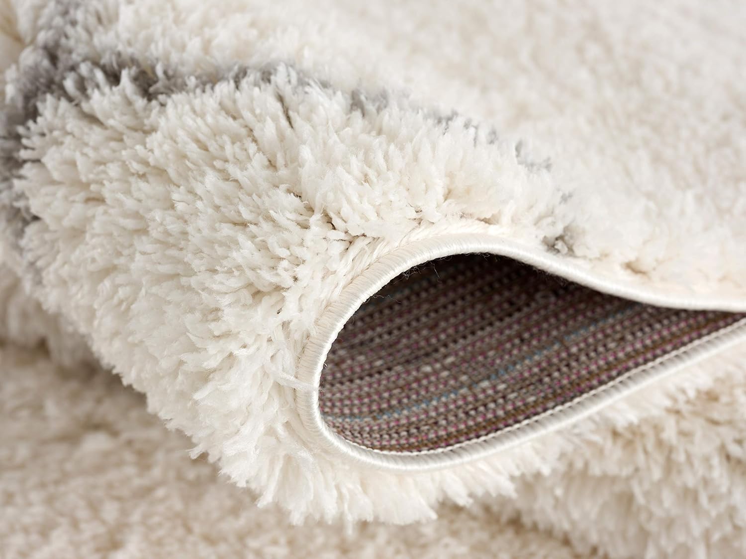 Close-up of fluffy, soft white carpet corner