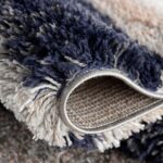 Close-up of textured, colorful shaggy carpet.