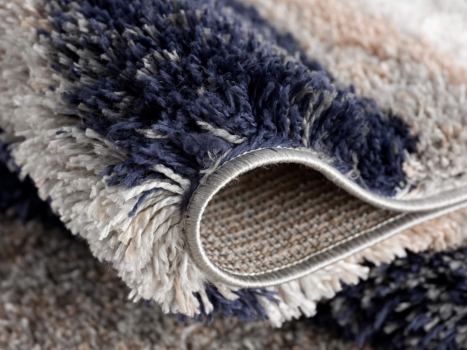 Close-up of textured, colorful shaggy carpet.