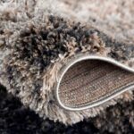 Close-up of soft, textured gray carpet.