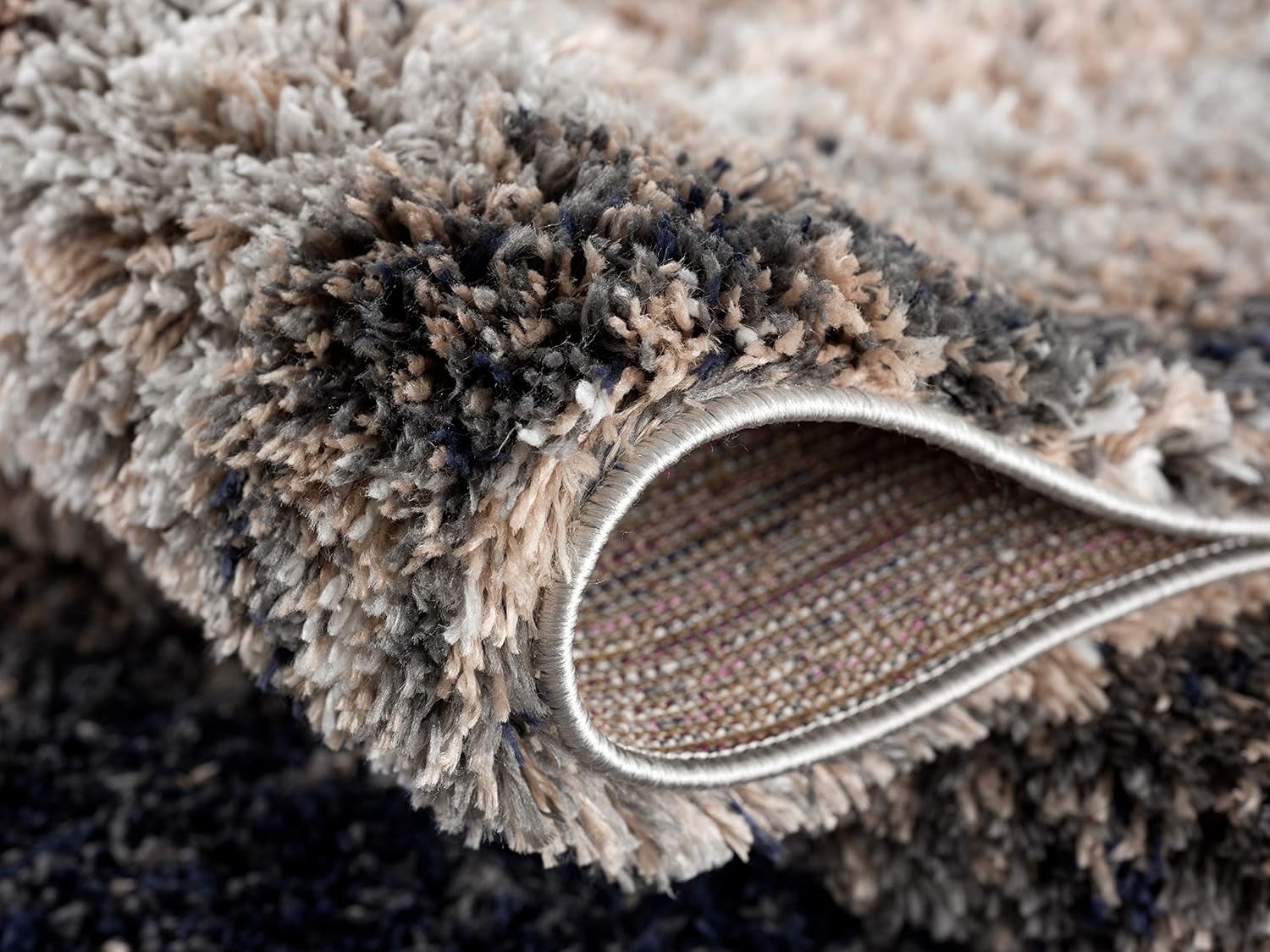 Close-up of soft, textured gray carpet.