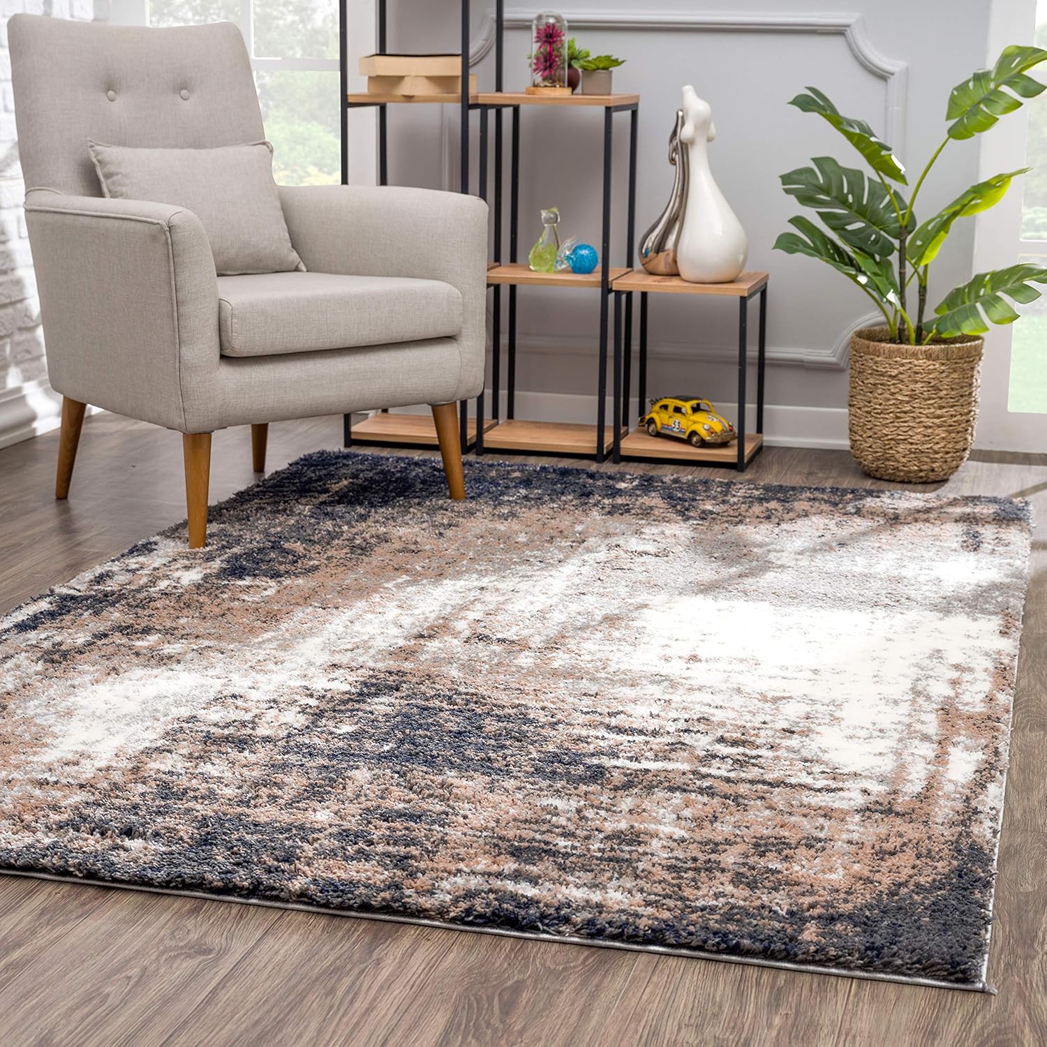 Modern living room with armchair and abstract rug.