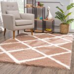 Modern room with geometric rug and armchair.