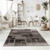 Modern dining room with geometric pattern rug.
