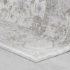Close-up of a corner of a patterned carpet.