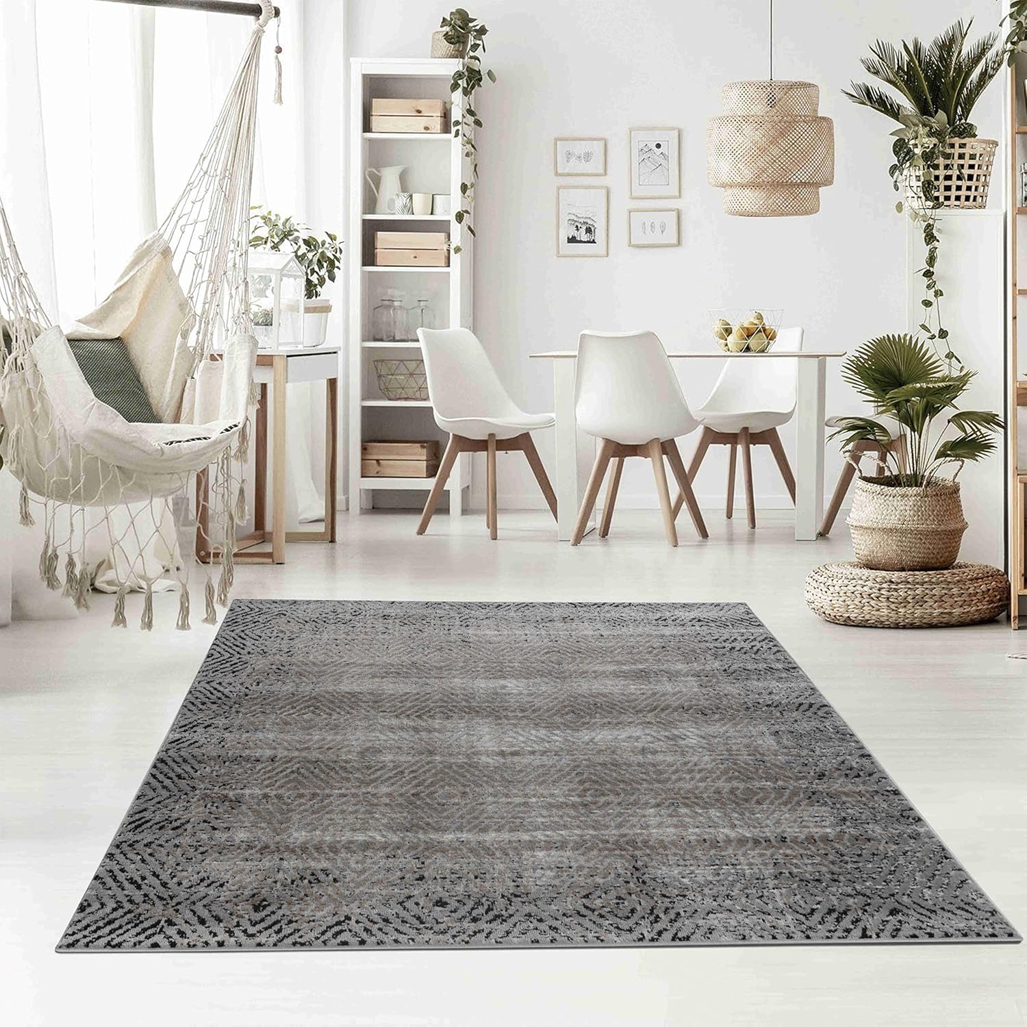 Modern dining area with gray geometric rug.