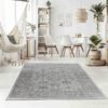 Bright room with rug, dining table, plants, and hammock.