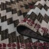 Geometric patterned rug with folded edge