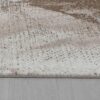 Close-up of beige textured rug on wood floor