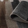 Folded multicolor patterned area rug corner close-up.