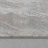 Gray textured rug on wooden floor