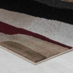 Textured area rug with bold stripes on floor.