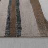 Striped gray and brown textured rug on floor.