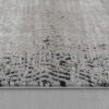 Close-up of textured monochrome carpet edge.